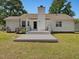 Rear exterior of home featuring a deck, a chimney, and a well-maintained lawn at 1230 Piney Glen Ln, Zebulon, NC 27597
