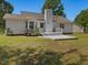 Back exterior of the house featuring a deck, a chimney, mature trees, and an enclosed yard at 1230 Piney Glen Ln, Zebulon, NC 27597