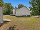 Back exterior of house featuring a deck, a brick foundation and fenced-in yard at 1230 Piney Glen Ln, Zebulon, NC 27597
