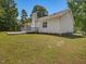 Back exterior of the house featuring a deck, a chimney, and a fenced-in yard at 1230 Piney Glen Ln, Zebulon, NC 27597