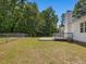 Spacious backyard featuring a deck, mature trees, and a chain-link fence at 1230 Piney Glen Ln, Zebulon, NC 27597