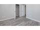 Bedroom showcasing wood-look flooring, fresh paint, two doors, and a walk-in closet at 1230 Piney Glen Ln, Zebulon, NC 27597