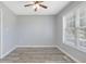Calm bedroom with wood flooring, ceiling fan, and ample natural light at 1230 Piney Glen Ln, Zebulon, NC 27597