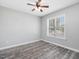 Serene bedroom featuring light gray walls, wood floors, and a ceiling fan at 1230 Piney Glen Ln, Zebulon, NC 27597