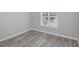 Bedroom featuring wood-look flooring, white trim and baseboards, and a window for ample natural light at 1230 Piney Glen Ln, Zebulon, NC 27597
