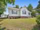 Lovely home with a manicured lawn, brick foundation, and white siding at 1230 Piney Glen Ln, Zebulon, NC 27597