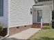 Charming home exterior with brick foundation and a blue door on a sunny day at 1230 Piney Glen Ln, Zebulon, NC 27597