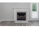 Close-up of the fireplace with marble accents and white trim, offering a cozy and elegant touch at 1230 Piney Glen Ln, Zebulon, NC 27597