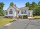 Inviting home with lush landscaping, brick foundation, and a spacious driveway at 1230 Piney Glen Ln, Zebulon, NC 27597
