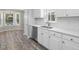 Kitchen with stainless steel appliances, granite countertops, white cabinets, and a bay window view at 1230 Piney Glen Ln, Zebulon, NC 27597