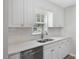 Stylish kitchen featuring white cabinetry, modern countertops, and stainless steel appliances, a chef's dream at 1230 Piney Glen Ln, Zebulon, NC 27597