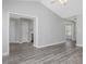 Open-concept living area with gray wood floors connects to a kitchen with stainless steel appliances at 1230 Piney Glen Ln, Zebulon, NC 27597
