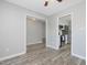 Open living room with gray wood flooring, white trim and doorways, creating a bright, inviting space at 1230 Piney Glen Ln, Zebulon, NC 27597