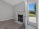 Cozy living room features a fireplace, access to the patio, and modern flooring at 1230 Piney Glen Ln, Zebulon, NC 27597