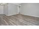 Spacious living room with modern, gray-toned wood flooring and neutral wall paint at 1230 Piney Glen Ln, Zebulon, NC 27597