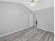 Spacious main bedroom with gray paint, modern ceiling fan, and attractive wood flooring at 1230 Piney Glen Ln, Zebulon, NC 27597