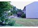 Multi tiered backyard features lush flowering plants, mature trees, and manicured lawn at 126 Willow Weald Ct, Fuquay Varina, NC 27526