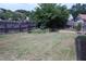 Large grassy backyard with wooden fence provides the perfect spot for activities at 126 Willow Weald Ct, Fuquay Varina, NC 27526