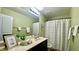 This is a bathroom with a single sink vanity, and a shower tub combo at 126 Willow Weald Ct, Fuquay Varina, NC 27526