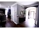 Inviting entryway features wood floors, neutral paint, granite countertop, and views into the kitchen and front door at 126 Willow Weald Ct, Fuquay Varina, NC 27526