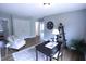 This is a flex space set up as a home office with desk and seating at 126 Willow Weald Ct, Fuquay Varina, NC 27526