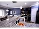 Stylish kitchen features granite countertops, stainless steel appliances, and seamless connection to the dining area at 126 Willow Weald Ct, Fuquay Varina, NC 27526