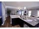Spacious kitchen with granite counters offering views of the living area with hardwood floors at 126 Willow Weald Ct, Fuquay Varina, NC 27526