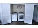 This laundry room has a modern washer and dryer behind stylish shuttered doors at 126 Willow Weald Ct, Fuquay Varina, NC 27526