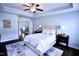Serene main bedroom features soft color palette, tray ceiling, plush bedding, and lots of natural light for a tranquil retreat at 126 Willow Weald Ct, Fuquay Varina, NC 27526