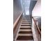 Classic stairway with wood treads, white risers, and contrasting railing, leading to the upper level of the home at 126 Willow Weald Ct, Fuquay Varina, NC 27526