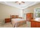 Spacious bedroom with tray ceilings, carpet floors, and natural light from the windows at 127 Bobwhite Way, Mebane, NC 27302