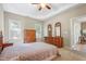 Bright bedroom featuring neutral tones, carpet, windows, and vintage wooden furniture at 127 Bobwhite Way, Mebane, NC 27302