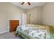 Bedroom showcasing a floral-patterned bed, carpet, dresser, and neutral wall color at 127 Bobwhite Way, Mebane, NC 27302