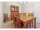 Traditional dining room with wooden table, chairs, hutch, neutral walls, and carpeted floors, perfect for Gathering gatherings at 127 Bobwhite Way, Mebane, NC 27302