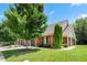 Charming brick home featuring lush greenery and well-manicured landscaping, providing a serene setting at 127 Bobwhite Way, Mebane, NC 27302