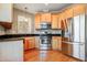 Well-lit kitchen features stainless steel appliances, ample wood cabinets, and dark countertops, great for cooking at 127 Bobwhite Way, Mebane, NC 27302