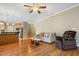 Spacious living area with hardwood floors and open access to the modern kitchen and comfortable seating arrangement at 127 Bobwhite Way, Mebane, NC 27302