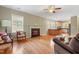 Cozy living room with fireplace, hardwood floors, and natural light, perfect for relaxing and entertaining guests at 127 Bobwhite Way, Mebane, NC 27302