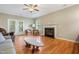 Bright living room with fireplace, hardwood floors, and patio access, offering seamless indoor-outdoor living experience at 127 Bobwhite Way, Mebane, NC 27302