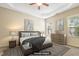 Calm main bedroom featuring tray ceiling, two windows, and tasteful decor at 127 Bobwhite Way, Mebane, NC 27302