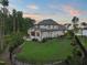 Large, fenced backyard with lush green lawn, stone accents, and an outdoor kitchen area at 1409 Montvale Ridge Dr, Cary, NC 27519