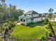 Aerial view of the backyard featuring lush landscaping, a fenced-in lawn, and an outdoor kitchen at 1409 Montvale Ridge Dr, Cary, NC 27519