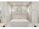 Bright bathroom featuring double shower heads, a soaking tub and sleek tile design at 1409 Montvale Ridge Dr, Cary, NC 27519