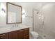 Modern bathroom with wood vanity, rectangular mirror, and glass-enclosed shower with tiled walls at 1409 Montvale Ridge Dr, Cary, NC 27519
