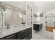 Modern bathroom featuring double vanity, large mirrors, and a luxurious glass-enclosed shower at 1409 Montvale Ridge Dr, Cary, NC 27519