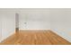 Spacious bedroom featuring hardwood floors, white walls, and a doorway leading to another room at 1409 Montvale Ridge Dr, Cary, NC 27519