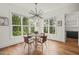 Bright dining area featuring hardwood floors, large windows, and a stylish modern light fixture at 1409 Montvale Ridge Dr, Cary, NC 27519