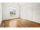 Bright empty room featuring hardwood floors, decorative wall, and a large bright window at 1409 Montvale Ridge Dr, Cary, NC 27519