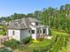 Back exterior view of home showcasing screened porch, patio with grill, fenced yard, and lush landscaping at 1409 Montvale Ridge Dr, Cary, NC 27519