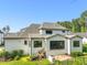 Back exterior view of home showcasing screened-in porch, patio with grill, and large fenced backyard at 1409 Montvale Ridge Dr, Cary, NC 27519